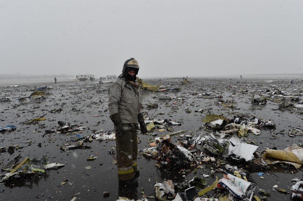 A Russian Emergency Ministry employee  stands next the wreckage of a crashed plane at the Rostov-on-Don airport, about 600 miles south of Moscow on Saturday.