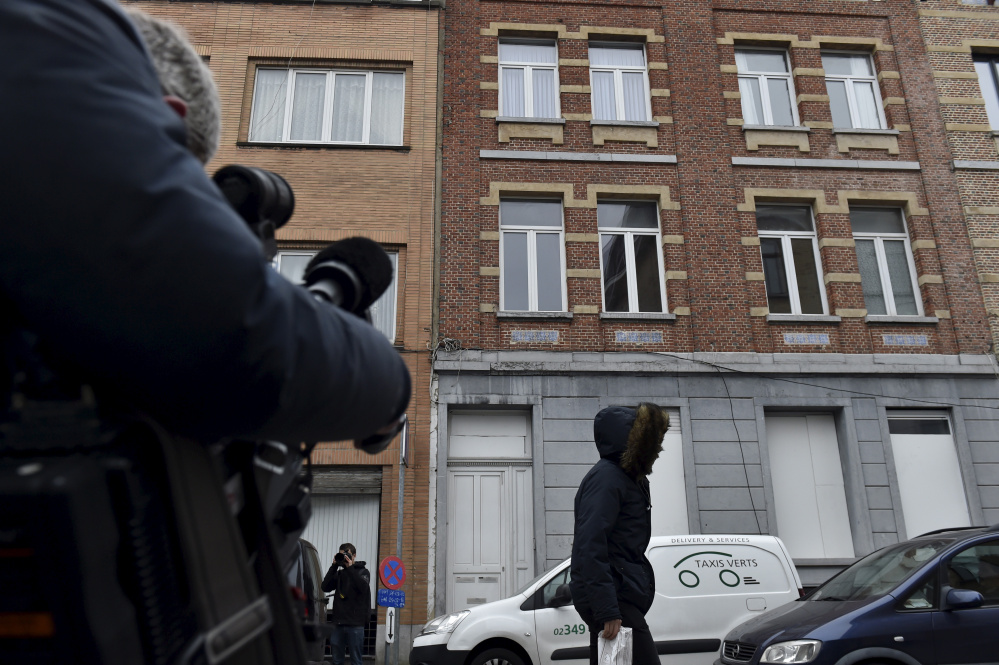A man walks in front of the house (C) where Salah Abdeslam, the most-wanted fugitive from November's Paris attacks, was arrested after a shootout with police on Friday in the Brussels district of Molenbeek, March 19, 2016. REUTERS/Eric Vidal   - RTSB6EU