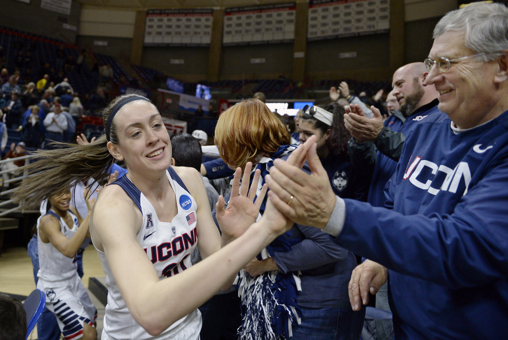 Connecticut’s Breanna Stewart greets fans at the end of the Huskies’ 101-49 rout of Robert Morris on Saturday in the first round of the women’s NCAA tournament. Connecticut led by 49 points at halftime.