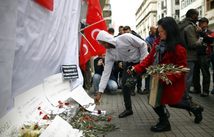 Tourists leave olive branches at the explosion site in Istanbul on Sunday.