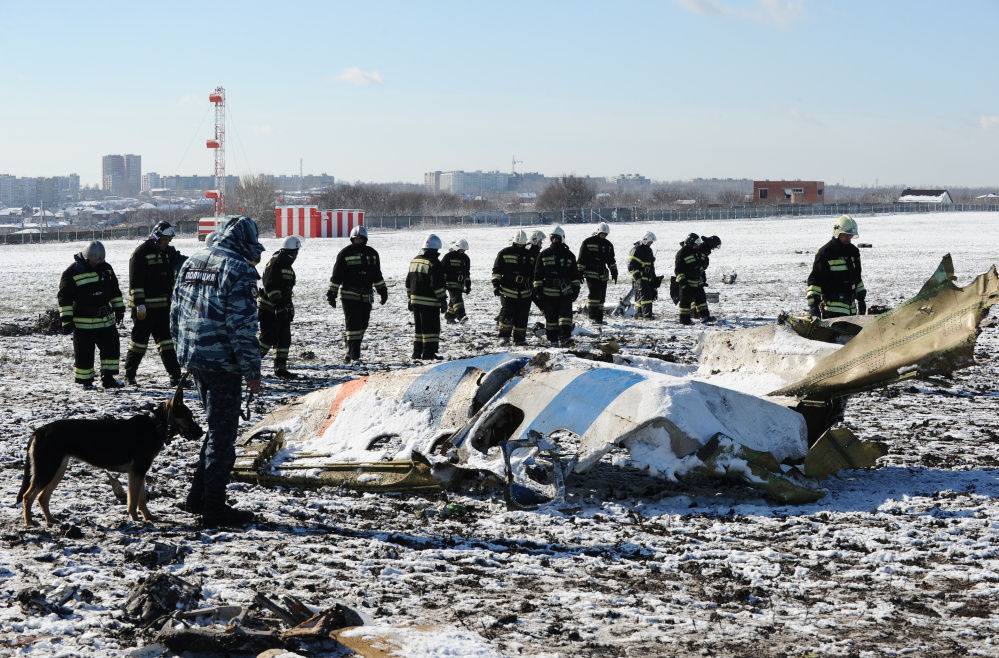 Russian Emergency Ministry employees investigate the wreckage of a crashed plane at the Rostov-on-Don airport, about 600 miles south of Moscow, on Sunday.