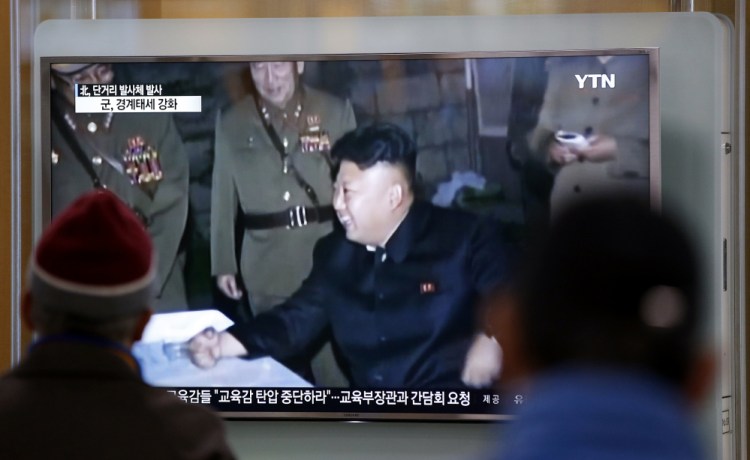 People watch a TV news program showing North Korean leader Kim Jong Un at Seoul Railway Station in Seoul, South Korea.