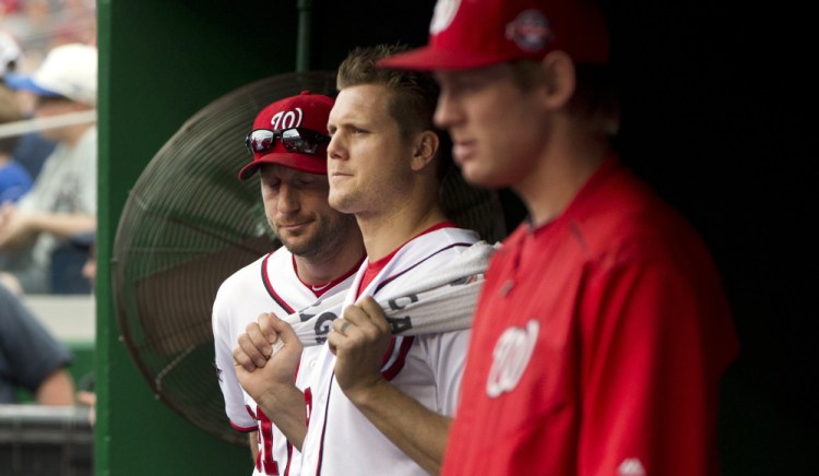 Washington pitchers Max Scherzer, left, Jonathan Papelbon, center, and Stephen Strasburg stand in the dugout last September 27 after Papelbon’s eighth-inning altercation with teammate Bryce Harper during a game against the Phillies.