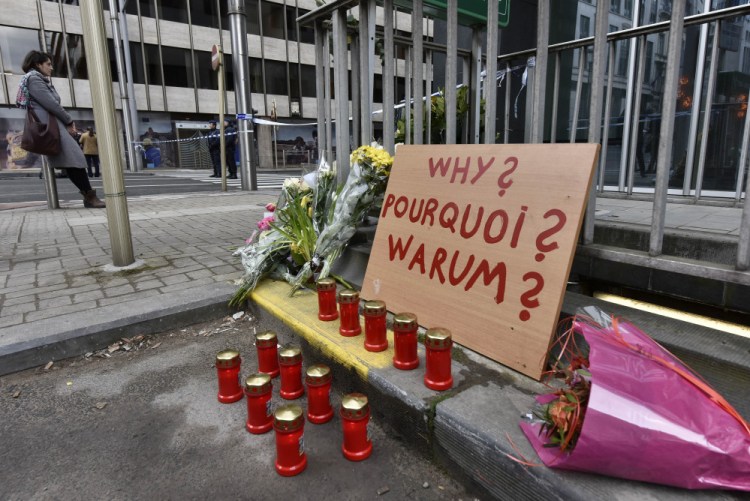 A sign reading “Why?” is placed near the metro station Maelbeek in Brussels on Wednesday, a day after bombs exploded at the Brussels airport and the metro stations, killing and wounding scores of people. The Islamic State has trained a network of agile and semiautonomous cells to carry out such attacks, the Associated Press reports.