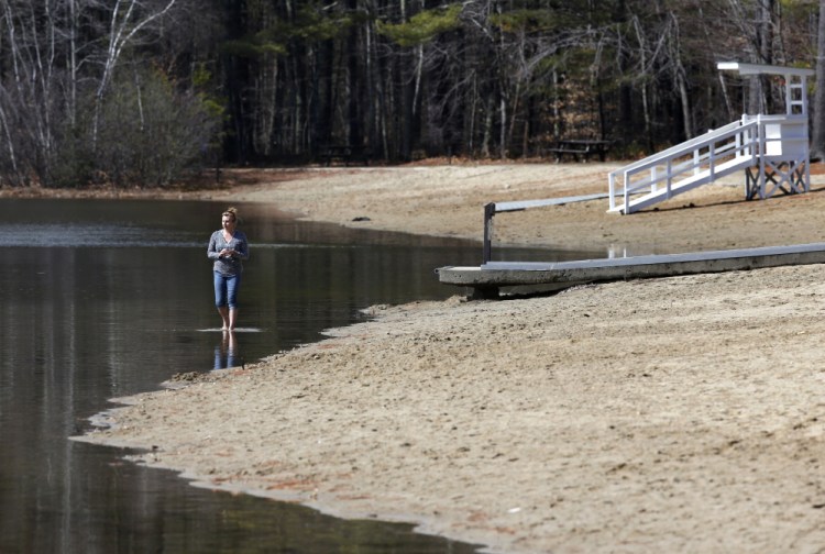 Roxanne Doyer of Mechanic Falls, Maine, walks barefoot in Lower Range Pond in Poland on March 17. Last year’s mud season started late because of heavy snow, and lasted until mid-May in some parts of northern New England. But this year’s mud season is already here in much of the three states, and meteorologists say it will likely be brief.