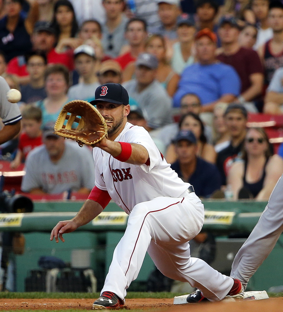 Travis Shaw of the Red Sox takes a throw at first base during a game last September. The 25-year-old can play either corner infield position, showed a promising bat in limited action last season, and has said he intends to play. There’s just one problem. Or two.