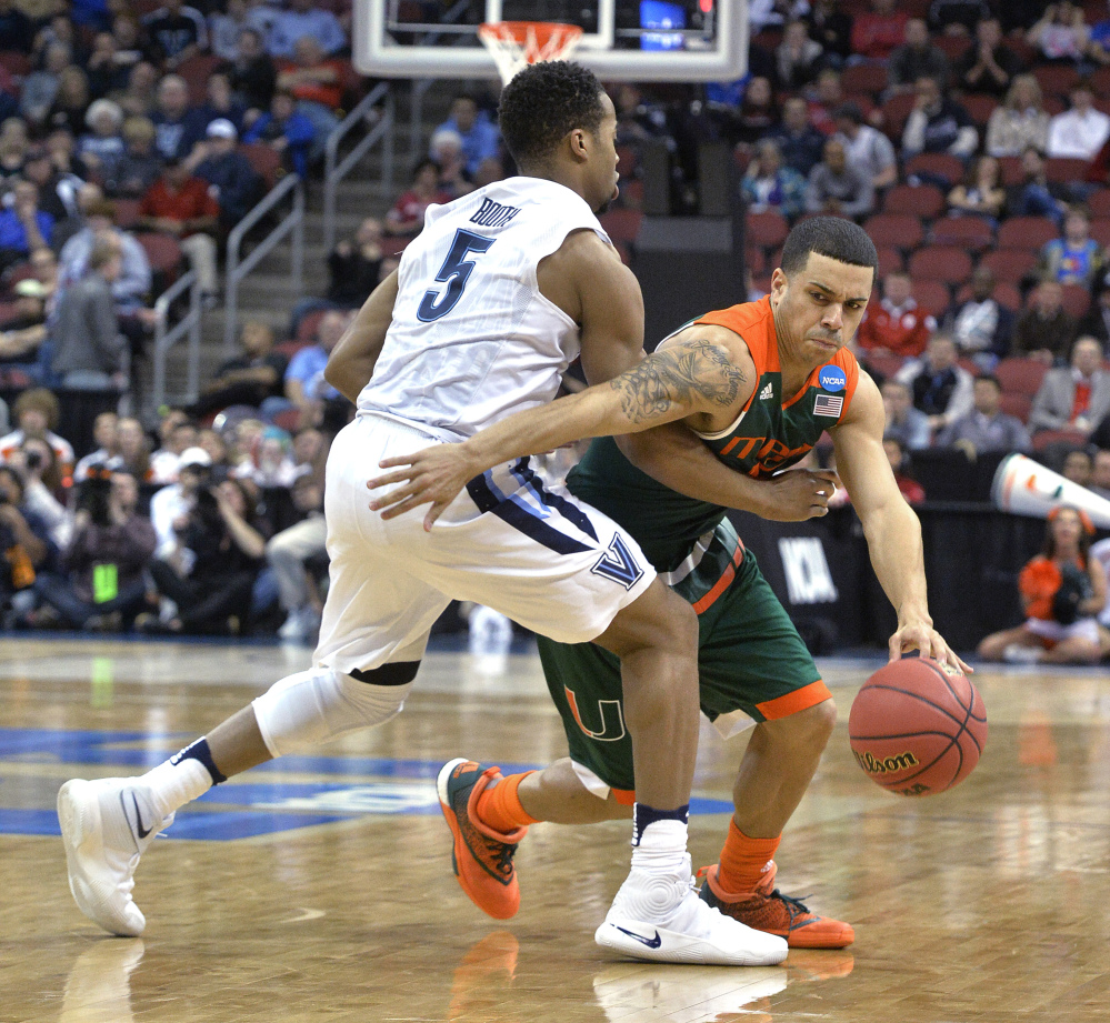Miami guard Angel Rodriguez tries to drive around Villanova guard Phil Booth in the first half. Villanova improved to 32-5 with the win and ended Miami’s season.