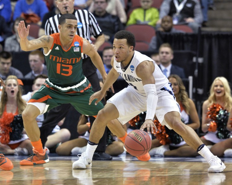 Villanova guard Jalen Brunson looks for help as Miami guard Angel Rodriguez defends during the first half of Thursday night’s game in the regional semifinals of the men’s NCAA Tournament in Louisville, Ky.