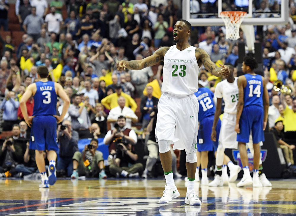 Oregon forward Elgin Cook celebrates the Ducks’ win over Duke on Thursday night in the regional semifinals of the NCAA tournament in Anaheim, Calif. Cook had 16 points and nine rebounds in the game.