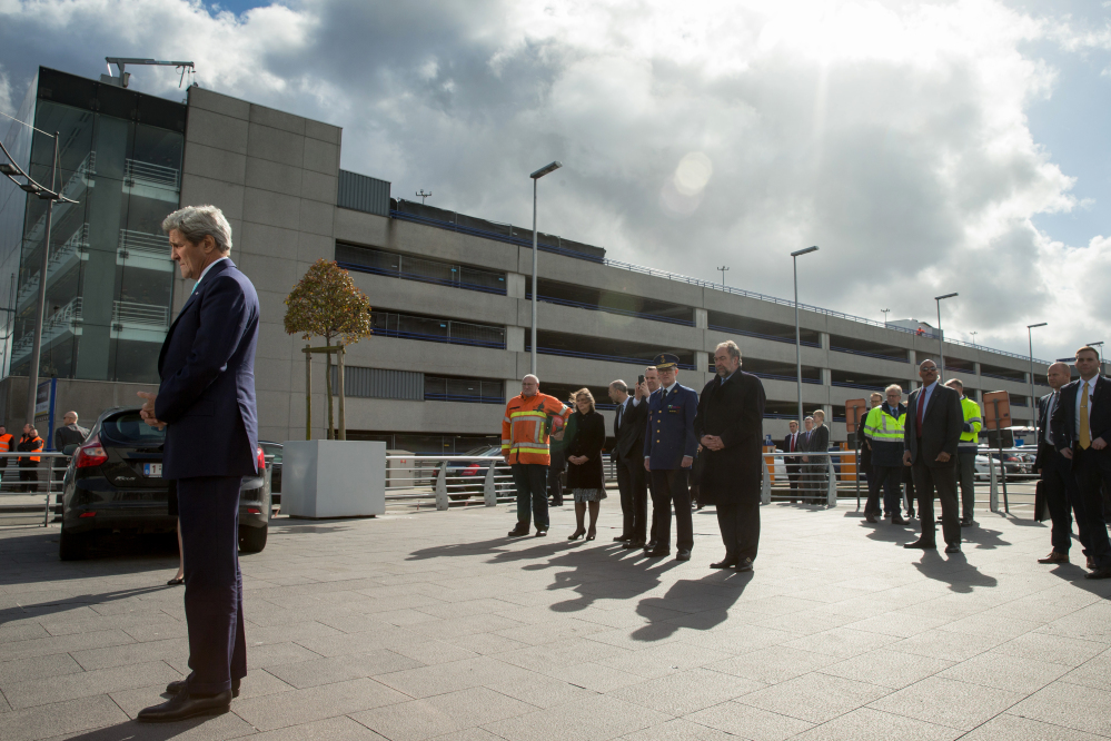 Secretary of State John Kerry stands in silence as he participates in wreath-laying at Brussels Airport in Brussels, Belgium, paying his respect to victims of terrorist attacks that left more than 30 dead at Brussels Airport.