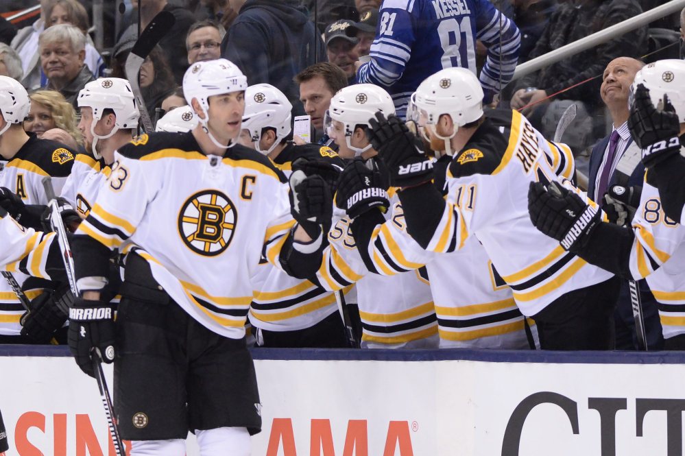 Boston Bruins’ Zdeno Chara (33) celebrates his goal with teammates during second-period action against the Toronto Maple Leafs Saturday.