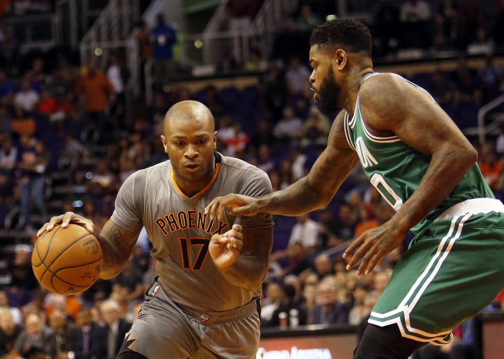 Phoenix Suns forward P.J. Tucker (17) drives on Boston Celtics forward Jae Crowder in the first quarter Saturday in Phoenix. (AP Photos/Rick Scuteri)
