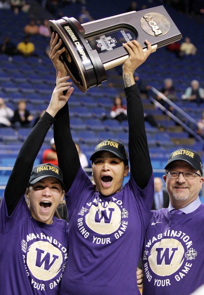 Washington’s Alexus Atchley, left, Talia Walton, center, and Coach Mike Neighbors celebrate after the Huskies beat Stanford 85-76 to win the Lexington Regional and advance to the NCAA women’s Final Four for the first time in school history, on Saturday in Lexington, Kentucky.
