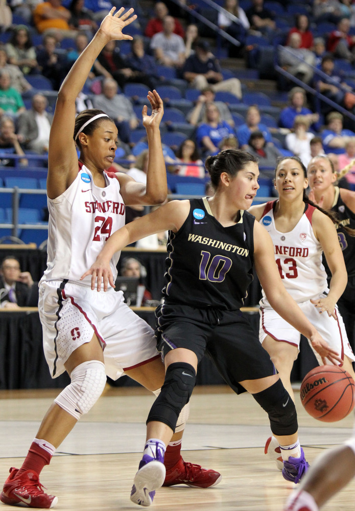 The Associated Press Washington’s Kelsey Plum (10) looks for an opening on Stanford’s Erica McCall (24) and Marta Sniezek (13).