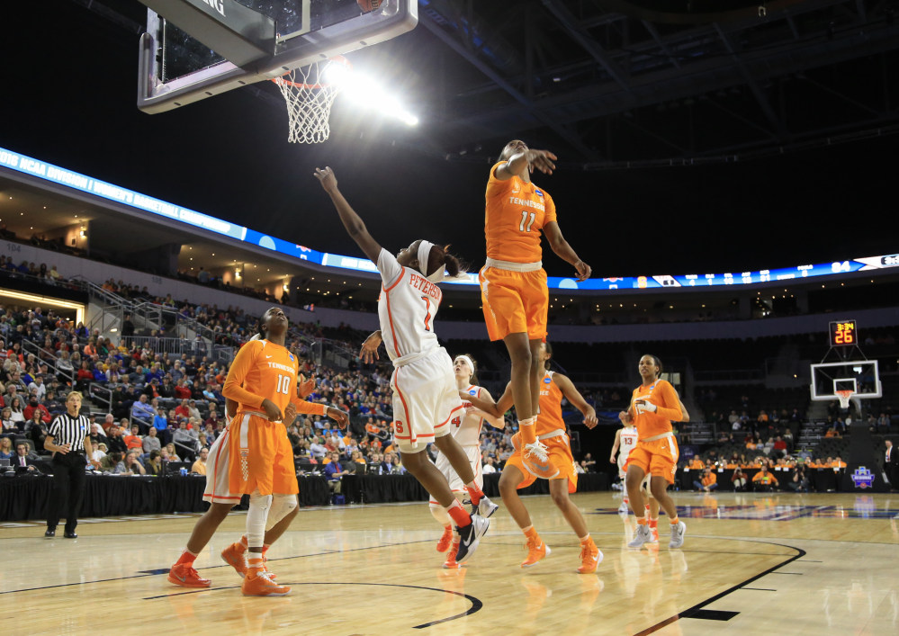 The Associated Press Syracuse’s Alexis Peterson (1) goes for a layup against Tennessee’s Diamond DeShields (11) and Meme Jackson (10).