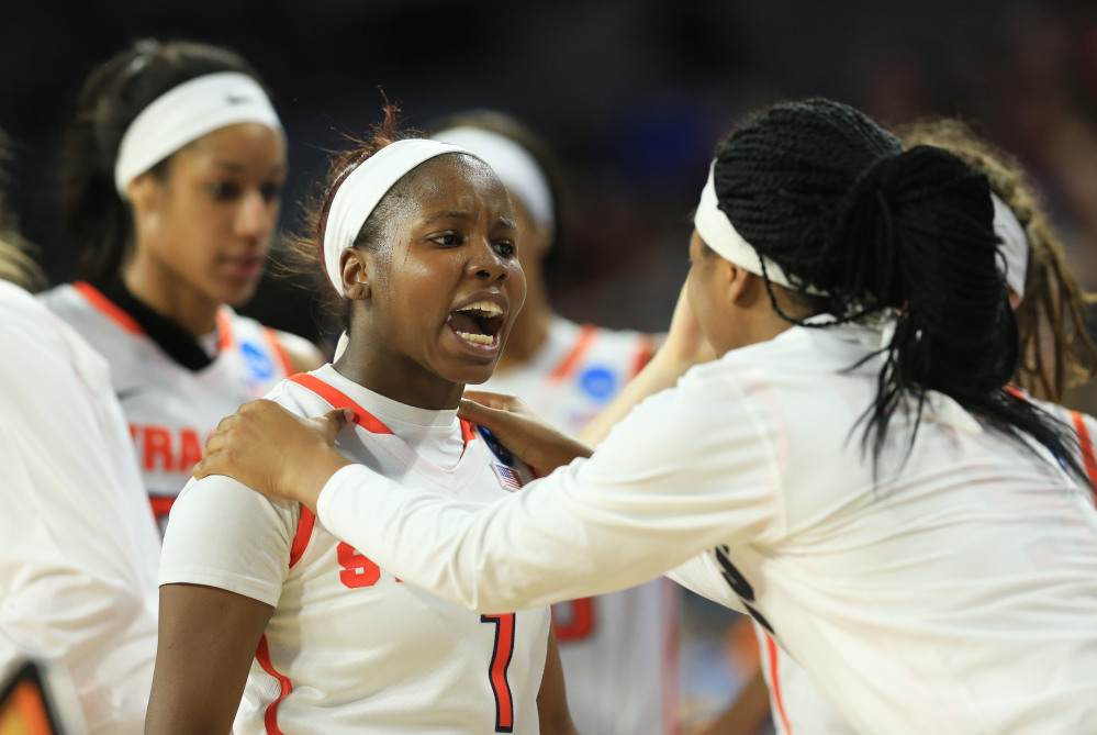 Syracuse’s Alexis Peterson, left, is greeted by Taylor Ford, right, during the Orange’s 89-67 win over Tennessee in the Sioux Falls Regional final Sunday.