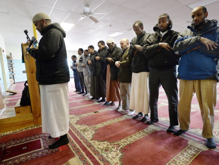 Muslim men pray at the Maine Muslim Community Center in Portland, led by imam Mohamed Abdirahman, left. He says the term “terrorist” isn’t applied equally when the perpetrators of violence aren’t Muslim – does the media ever call a non-Muslim attacker “a Christian terrorist?”