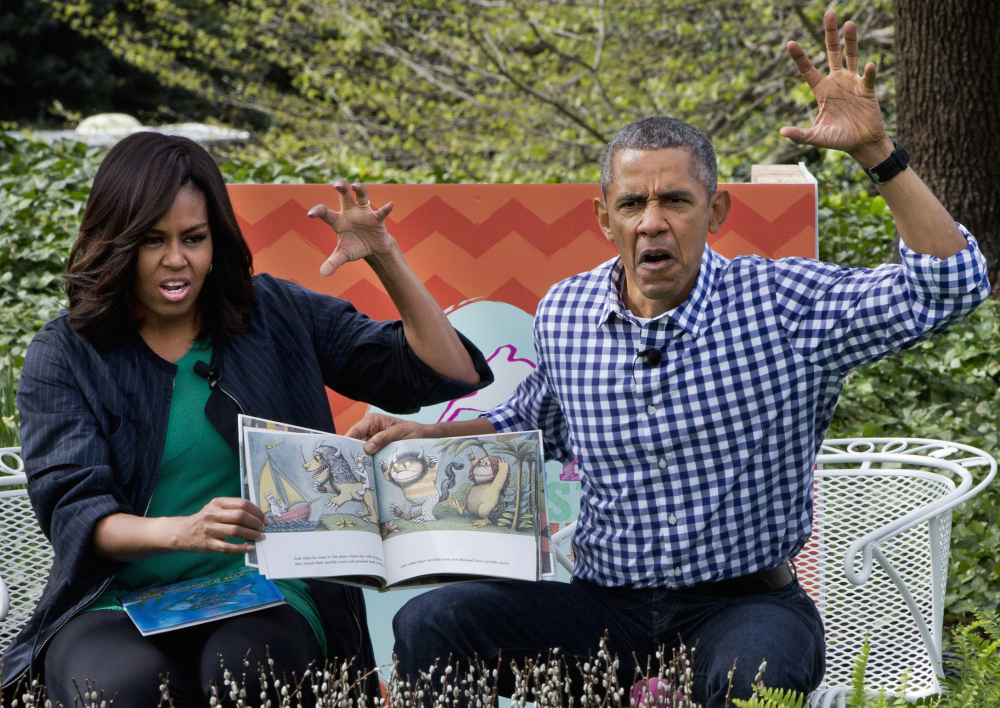 President Obama and first lady Michelle Obama make claw hands and monster faces while reading “Where the Wild Things Are,” during the president’s final Easter Egg Roll at the White House in Washington on Monday.