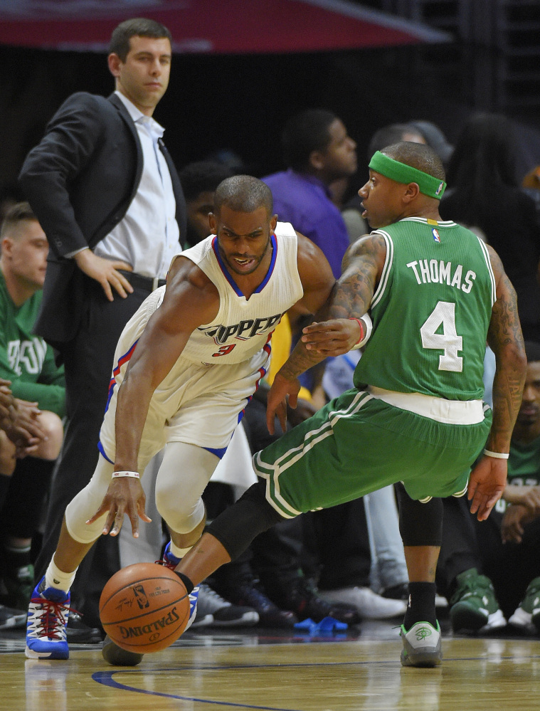 Clippers guard Chris Paul drives past Celtics guard Isaiah Thomas in the first half of Monday night’s game in Los Angeles. Paul had 13 points and 14 assists in the game, while Thomas led the Celtics with 24 points.