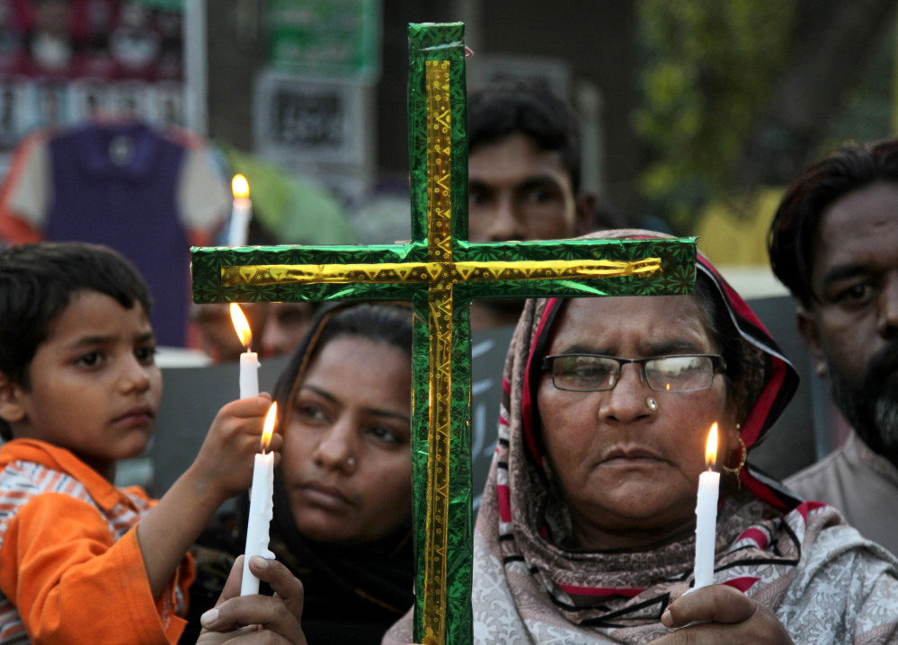 Pakistani Christians hold candles during vigil for the victims of Sunday’s suicide bombing in Lahore, Pakistan, on Tuesday. The government had vowed to crack down on extremism after a suicide bomber targeted Christians celebrating Easter in Lahore, killing more than 70 people.