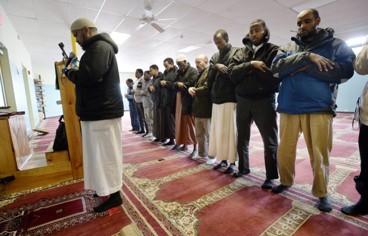 Muslim men pray at the Maine Muslim Community Center in Portland last week. Many of the estimated 6,000 Muslims in Maine – including the center’s director, Ahmed Abdiraham, who fled civil war in Somalia – came here to get away from brutality and conflict.