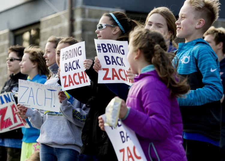 Members of the Manta Rays swim team protest the firing of their head coach, Zach Gray, outside the YMCA in Biddeford on Wednesday. Gray was the head coach for two years and was the 2015 Maine YMCA Coach of the Year.