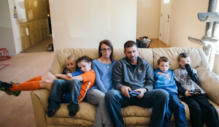 Annette Shattuck, who sought to set up a legal marijuana dispensary, sits with her family in Port Huron, Michigan.