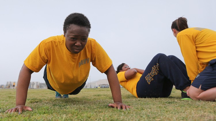Petty Officer Lentoyi White does pushups while training with fellow Petty Officer Theresa White in Coronado, Calif. The pair are trying to lose weight and improve their fitness in order to pass the Navy fitness test and avert being discharged. 