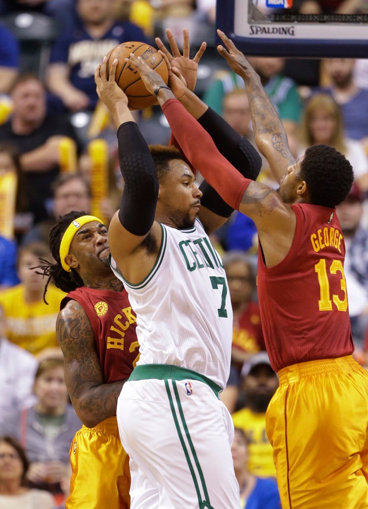 Boston's Jared Sullinger (is boxed in by Indiana's Paul George and Jordan Hill on Tuesday night.   The Associated Press