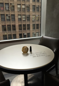 A table in the Renaissance Hotel in Manhattan is adorned with a quote attributed to fashion designer Karl Lagerfeld: "One is never over- or under-dressed with a little black dress." The Associated Press