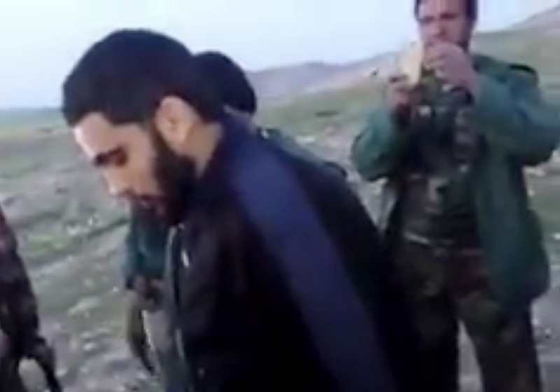 This image made from video posted on Twitter by a Kurdish fighter shows a man that the Kurdish military says is an American member of the Islamic State group shortly after he turned himself in to Kurdish fighters in northern Iraq.