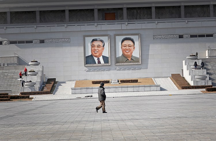 A man walks past portraits of the late North Korean leaders Kim Il Sung and Kim Jong Il, at the Kim Il Sung Square on Feb. 14, 2016, in Pyongyang. North Korea launched a rocket Feb. 7, carrying what it said was an Earth observation satellite into space. World leaders called it a  banned test of ballistic missile technology and another "intolerable provocation." The Associated Press