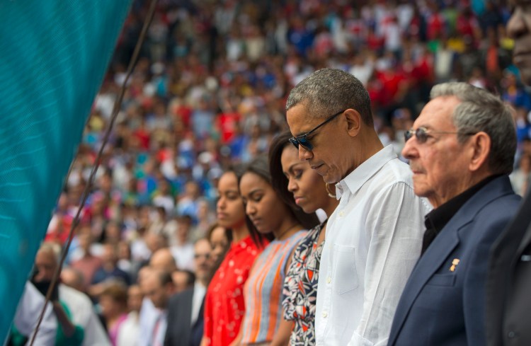 President Obama, Cuban President Raul Castro, and members of the first family pause during a moment of silence for the attacks in Brussels before the start of an exhibition baseball game between the Tampa Bay Rays and the Cuban National team.   The Associated Press