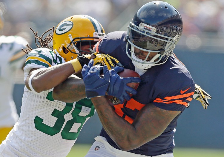 Chicago Bears tight end Martellus Bennett is pursued by Green Bay Packers cornerback Tramon Williams in this 2014 photo. The New England Patriots acquired Bennett from the Bears on Thursday, giving them another talented tight end to pair with All-Pro Rob Gronkowski. The Associated Press