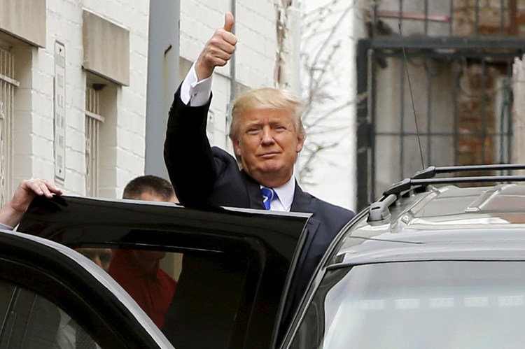 Donald Trump waves to onlookers and reporters as he leaves through a back door Thursday after meetings at Republican National Committee headquarters in Washington.
Reuters/Jonathan Ernst
