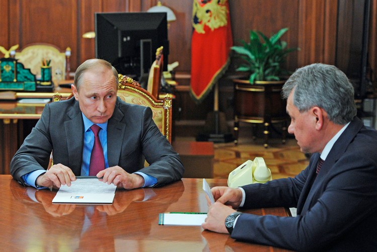 Russian President Vladimir Putin listens to Russian Defense Minister Sergey Shoygu during their meeting in the Kremlin Monday. The Associated Press