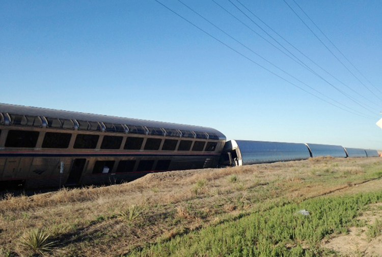 Cars from an Amtrak passenger train lie on their side Monday morning near Cimarron, Kan., after a derailment shortly after midnight resulting in multiple injuries. The Associated Press