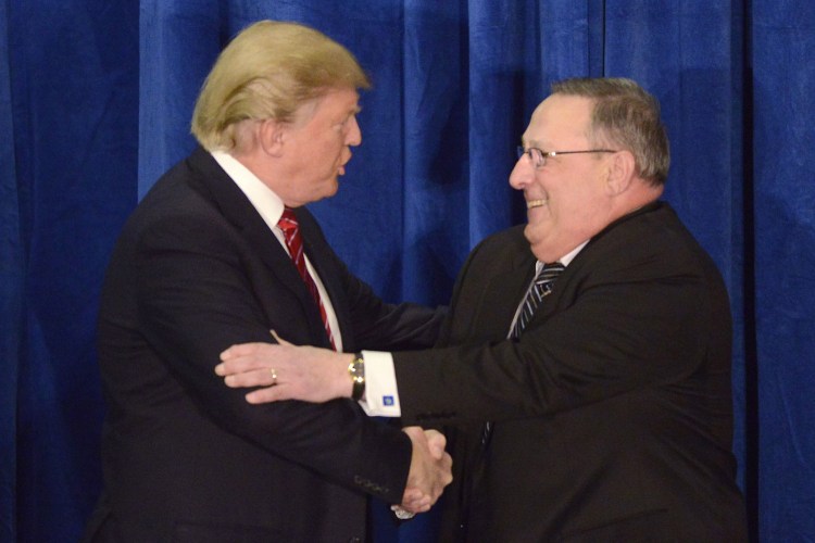 Donald Trump shakes hands with Gov. Paul LePage during a March campaign appearance in Portland.