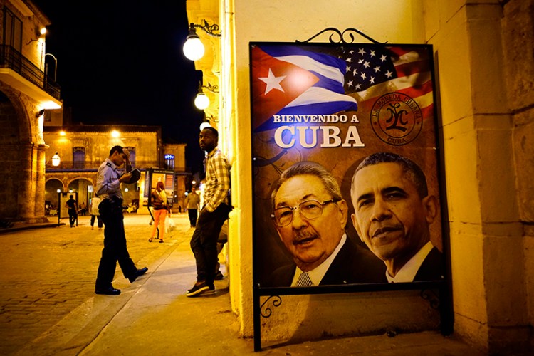 A poster features portraits of Cuba's President Raul Castro and U.S. President Barack Obama and reads in Spanish "Welcome to Cuba" outside a restaurant in Havana.