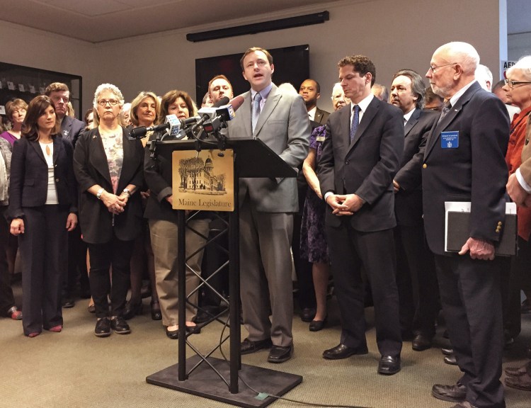 House Speaker Mark Eves of North Berwick is surrounded by members of the Maine House and Senate Democratic caucus on Thursday as the lawmakers announce a series of proposed changes to Maine's welfare laws.
