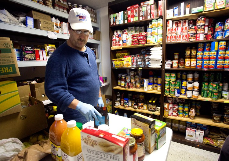 Kurt Fortman, a volunteer, sorts food Monday at the Old Orchard Beach Community Food Pantry, which will lose about a quarter of its food because of the closure of Food Rescue of York County.