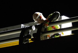 A worker tightens bolts on a guardrail of the Bath viaduct Wednesday night. Joel Page/Staff Photographer