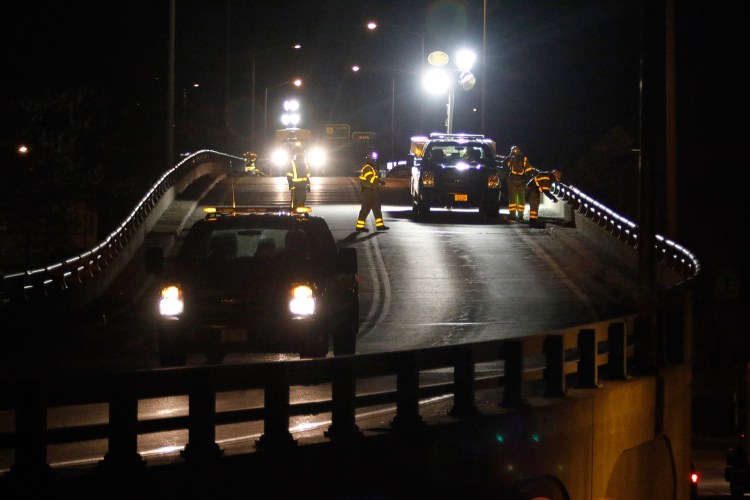 Department of Transportation workers inspect and tighten bolts Wednesday night along a guardrail on the Bath viaduct, where an SUV broke through a guardrail on April 4 and fell to the road below.