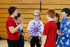 Emily Seavey, center, listens as coach Melanie Desjardins, left, speaks with Team B about their production. From left are team members Sammy Desjardins, Seavey, Declan McPartlan, Ella Romano and Jack Armstrong. Two teams from Lyseth Elementary, including Adrian Boothby and Hannah Dionne (not pictured), are rehearsing for the competition. 