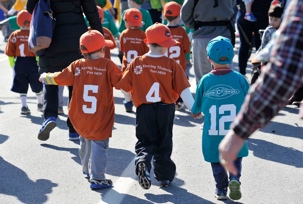 Young Little Leaguers march in the parade during Opening Day ceremonies in Portland on Saturday.