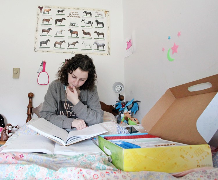 Emma Verrill, 14, studies math in her bedroom in North Yarmouth. 