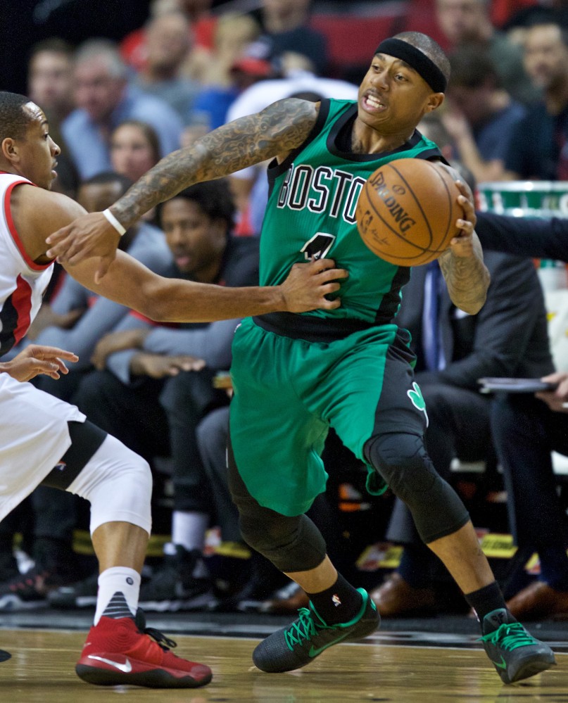Celtics guard Isaiah Thomas dribbles around Portland guard C.J. McCollum in the first half. Thomas led the Celtics with 22 points in the game.