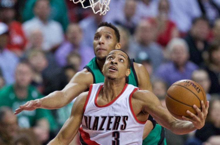 Trail Blazers guard C.J. McCollum shoots over Celtics guard Evan Turner in the first half of Thursday night's game in Portland, Ore.