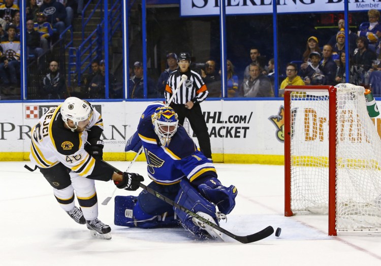 The Bruins' David Krejci scores one of his two goals against Blues goalie Brian Elliott in the first period. Krejci had two goals and two assists in the game.