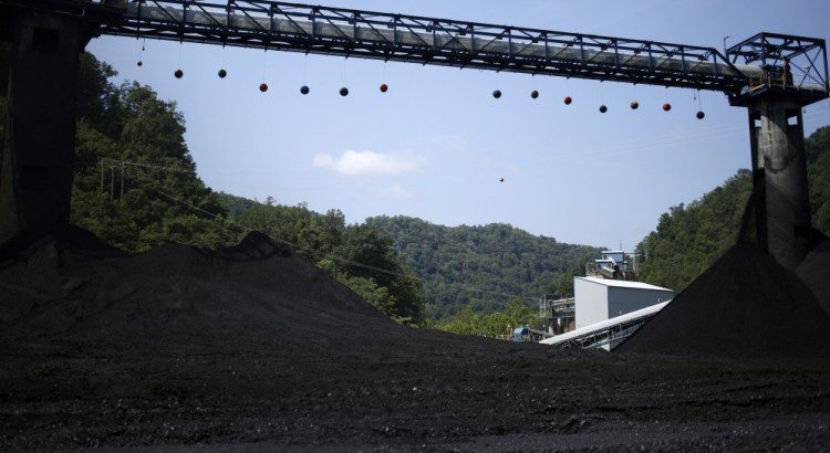 Mounds of coal sit beneath conveyor belts at an Alpha Natural Resources, a coal preparation plant in Logan County near Yolyn, W. Va., that filed for bankruptcy in 2015. Costs for cleanup of such sites could fall on taxpayers.